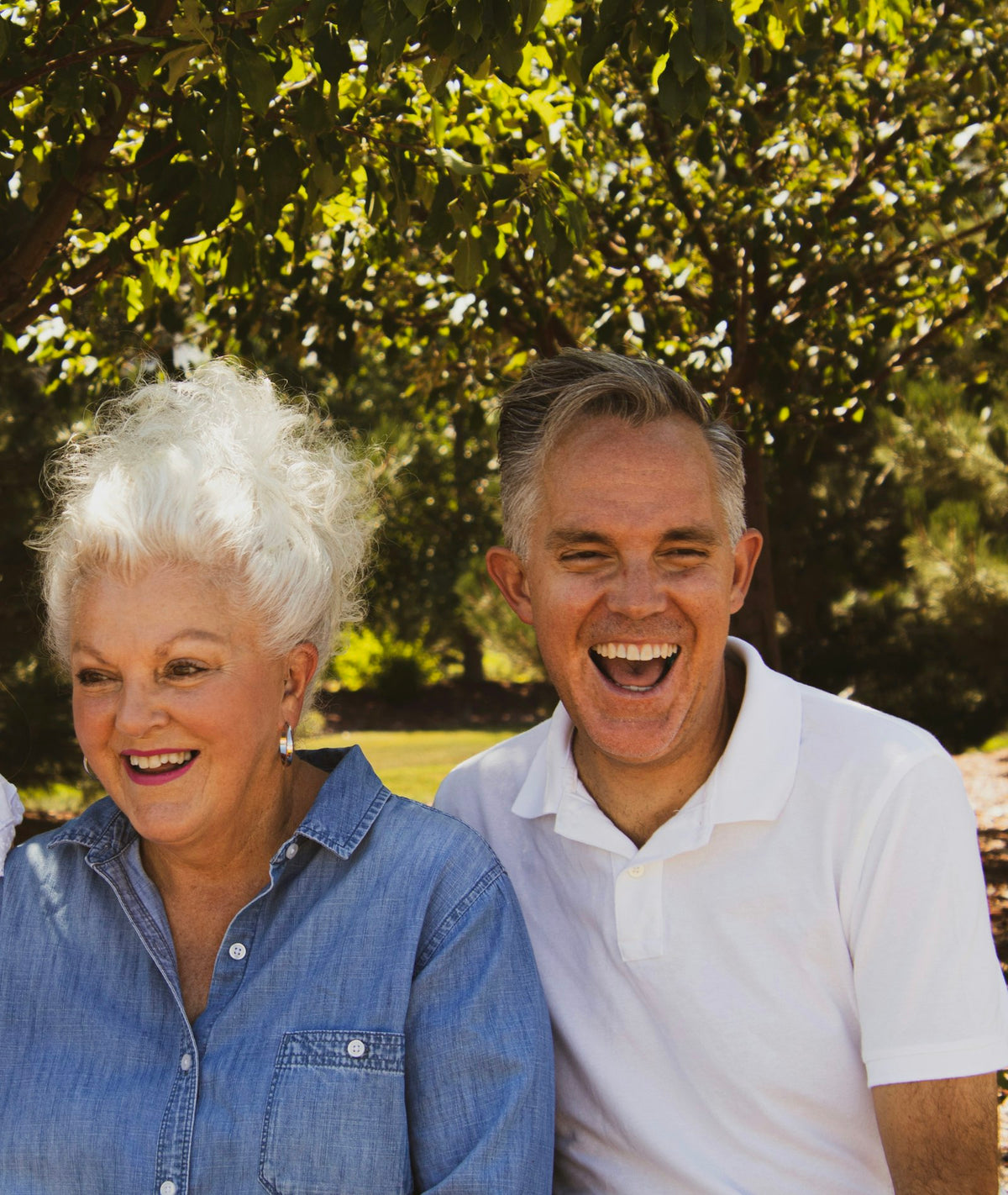 Laughing older woman and man outdoors